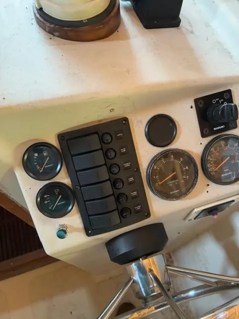 Slide: The Image of 1990 Custom North End Composites Point boat dashboard with gauges and controls. - 5