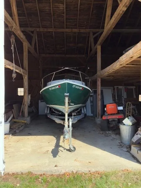 Slide: The Image of A 1990 Custom North End Composites Point boat stored in a wooden garage. - 6