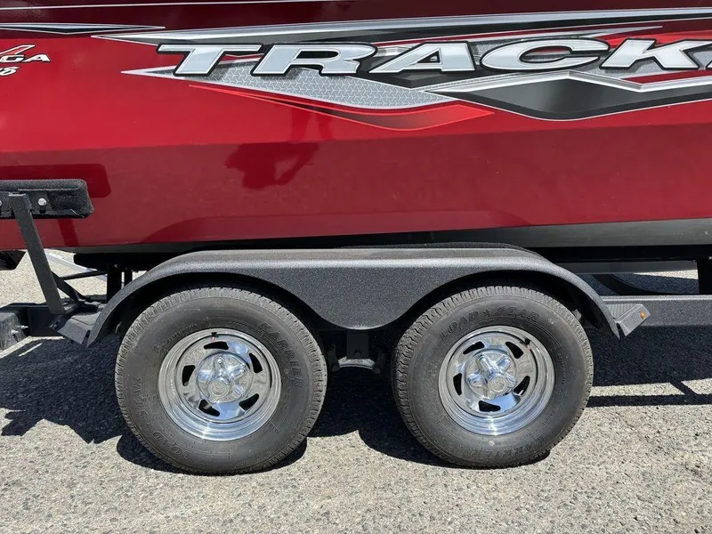 Slide: The Image of 2024 Tracker Targa™ V-18 Combo boat trailer with dual wheels, red and black design. - 11