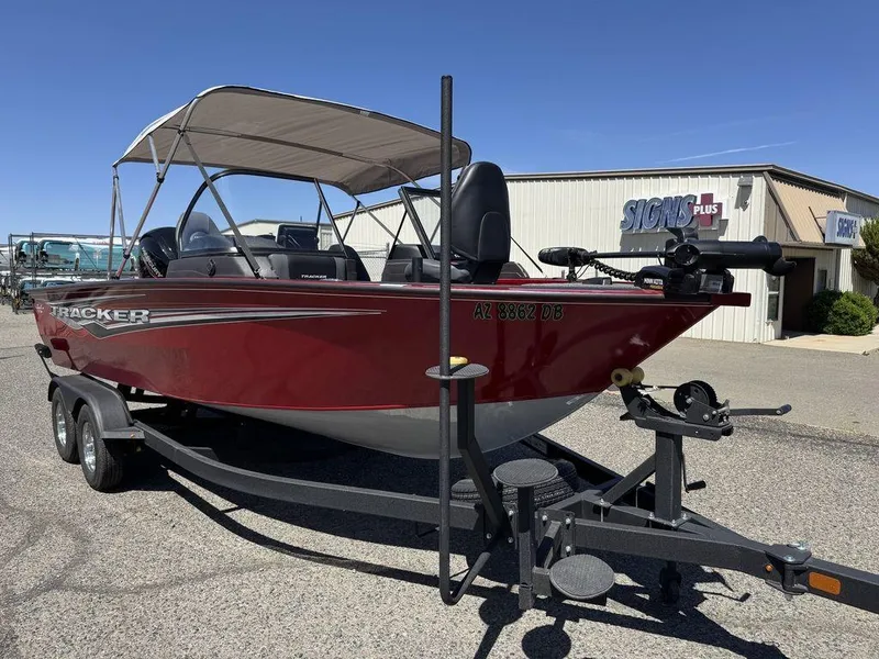 Slide: The Image of 2024 Tracker Targa™ V-18 Combo boat on trailer, red exterior, parked outdoors. - 14