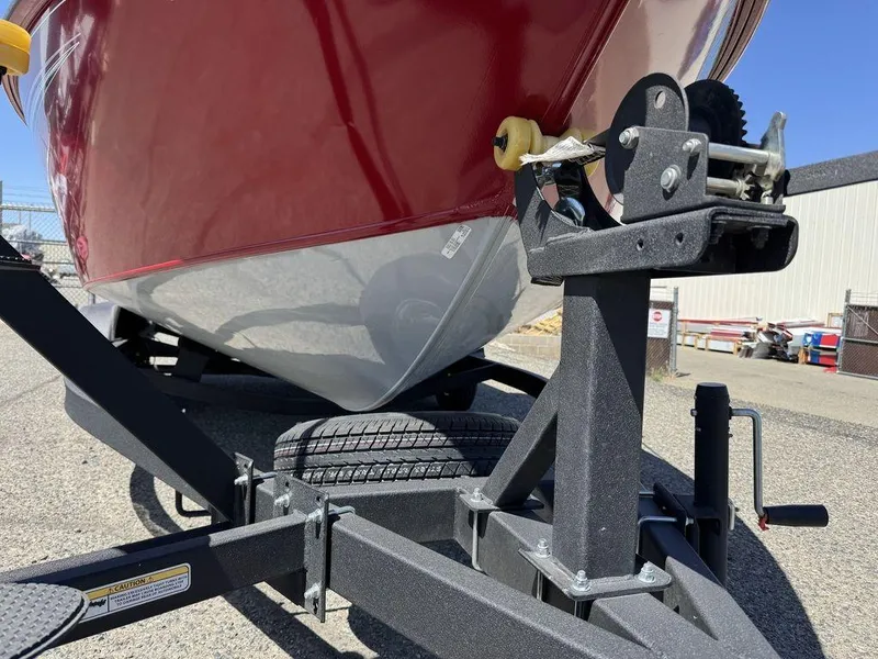 Slide: The Image of 2024 Tracker Targa™ V-18 Combo boat on trailer, close-up of red hull and winch. - 18