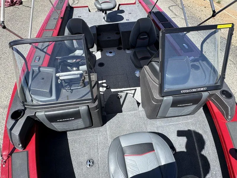 Slide: The Image of 2024 Tracker Targa™ V-18 Combo boat interior with seating and windshield, featuring a red and gray design. - 20