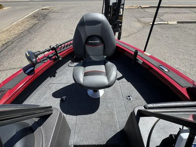 Slide: The Image of 2024 Tracker Targa™ V-18 Combo boat interior with a central seat and fishing equipment. - 22