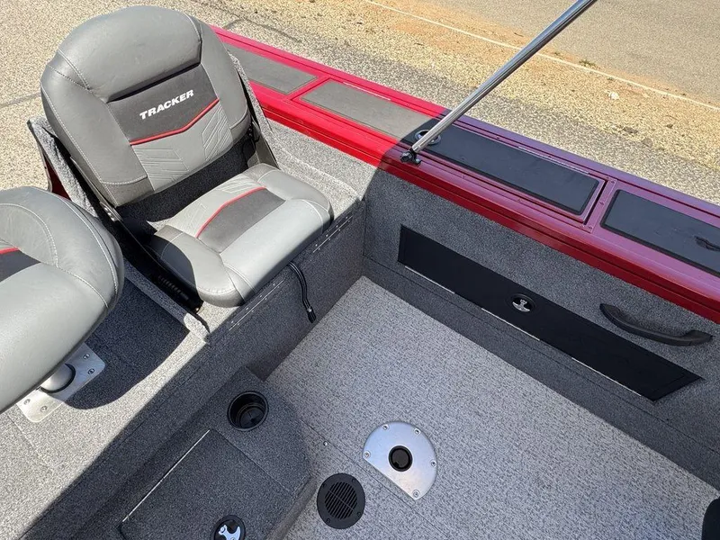 Slide: The Image of 2024 Tracker Targa™ V-18 Combo boat interior with gray seating and red accents. - 32