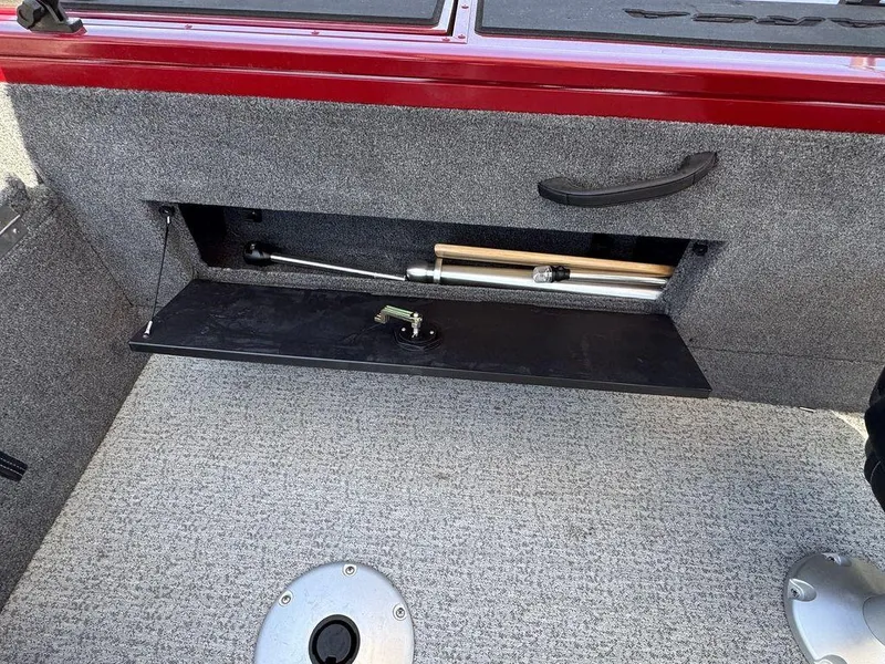 Slide: The Image of 2024 Tracker Targa™ V-18 Combo boat storage compartment with hydraulic lift and carpeted interior. - 36