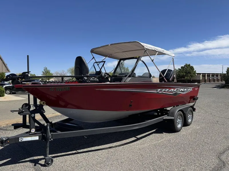 Slide: The Image of 2024 Tracker Targa™ V-18 Combo boat on trailer, red exterior, parked outdoors. - 39