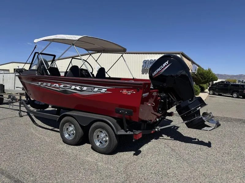 Slide: The Image of 2024 Tracker Targa™ V-18 Combo boat with Mercury outboard engine, parked on a trailer. - 42