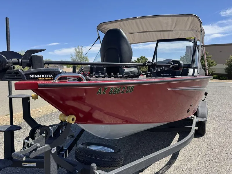 Slide: The Image of 2024 Tracker Targa™ V-18 Combo boat with Minn Kota motor on trailer, red exterior. - 49