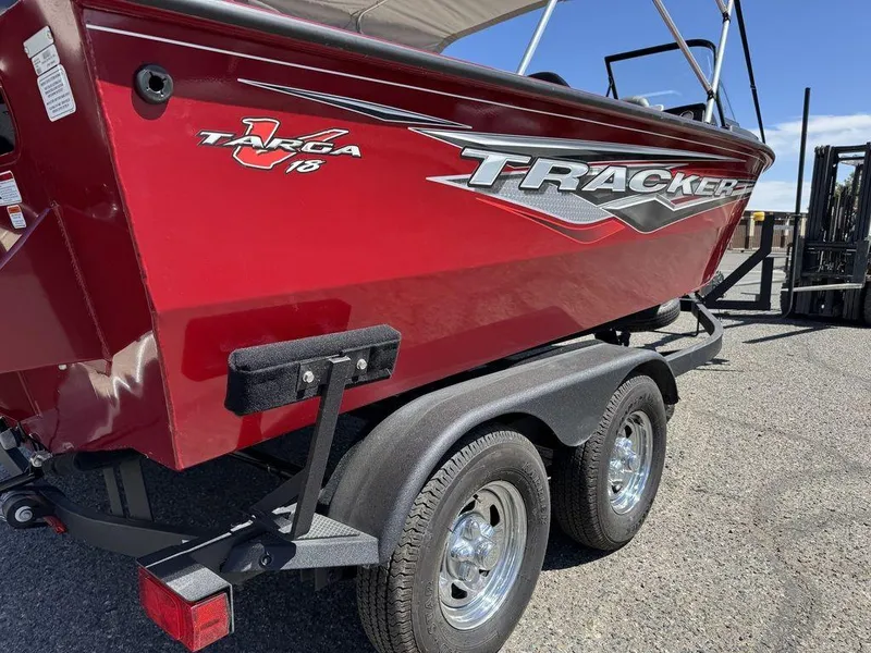 Slide: The Image of 2024 Tracker Targa V-18 Combo boat on trailer, red exterior, sunny day. - 9