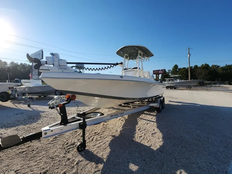 Slide: The Image of 2025 Skeeter SX2350 boat on trailer under clear blue sky. - 9
