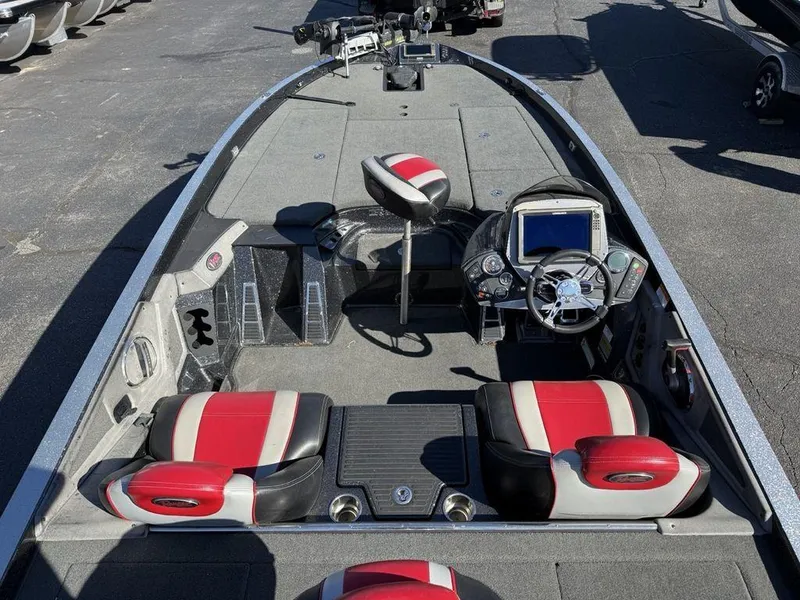 Slide: The Image of 2016 Ranger Z520C boat interior with red and gray seats, steering console, and fishing equipment. - 4