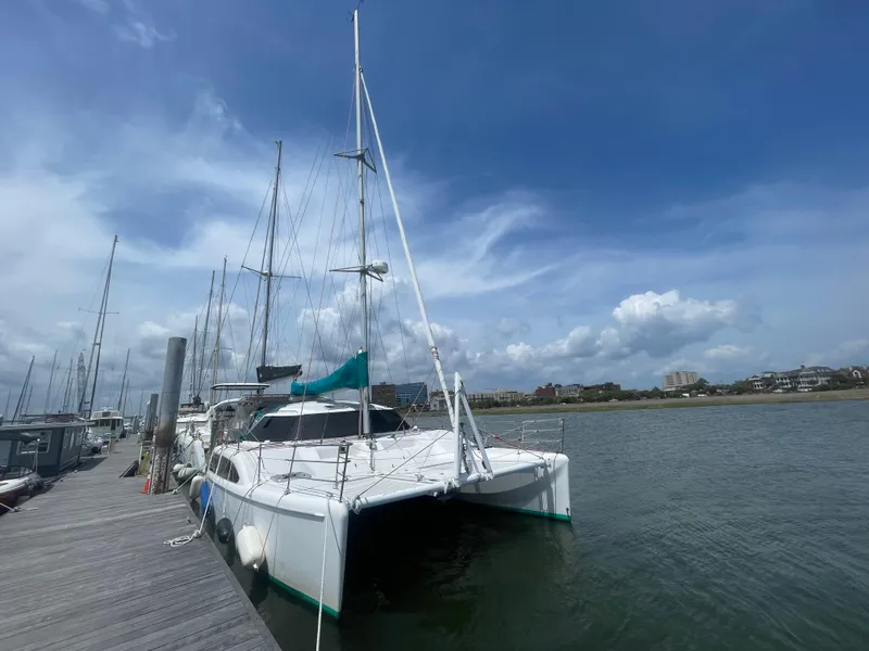 Slide: The Image of 2001 Seawind 1000 catamaran docked under a clear blue sky. - 1
