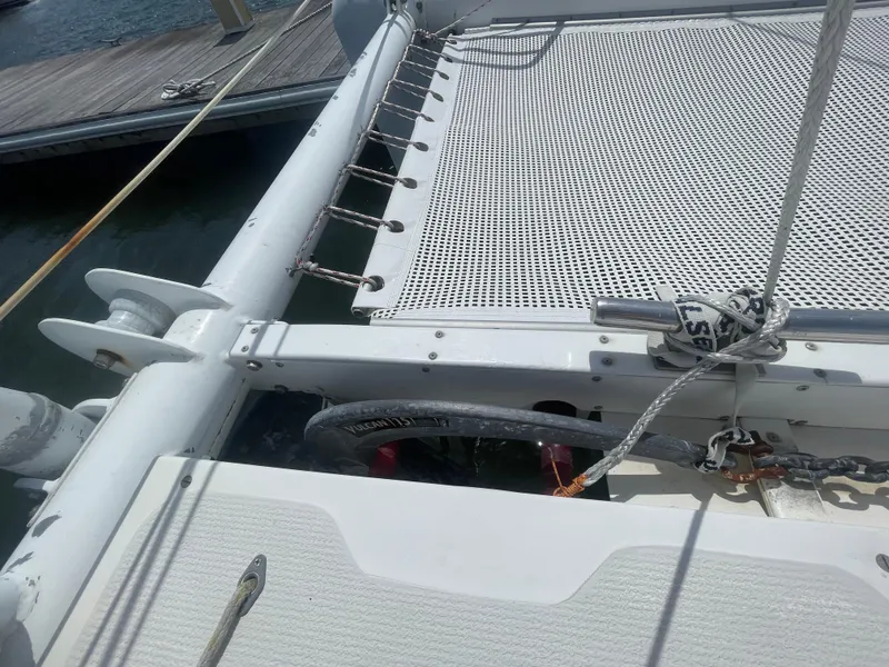 Slide: The Image of Seawind 1000 catamaran deck, 2001 model, featuring netting and docked at marina. - 14