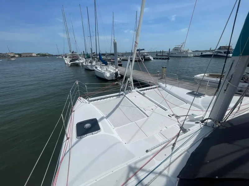 Slide: The Image of Seawind 1000 catamaran, 2001 model, docked at marina with other sailboats. - 20