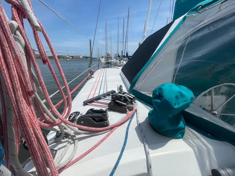 Slide: The Image of Seawind 1000 sailboat deck with ropes and equipment, docked in a marina, 2001 model. - 22