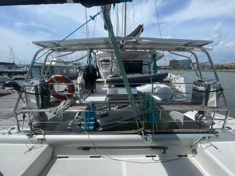 Slide: The Image of Seawind 1000 catamaran, 2001 model, docked with lifebuoy and equipment on deck. - 31