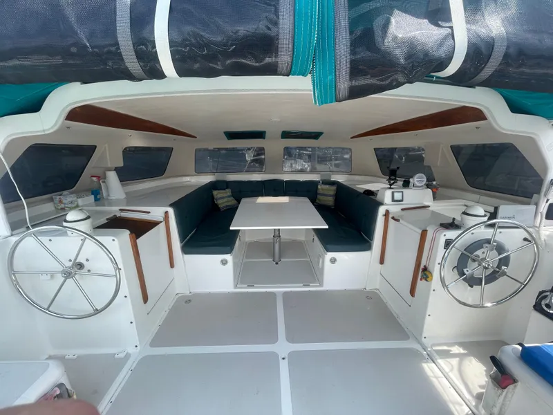 Slide: The Image of 2001 Seawind 1000 catamaran interior with dual steering wheels and spacious seating area. - 38