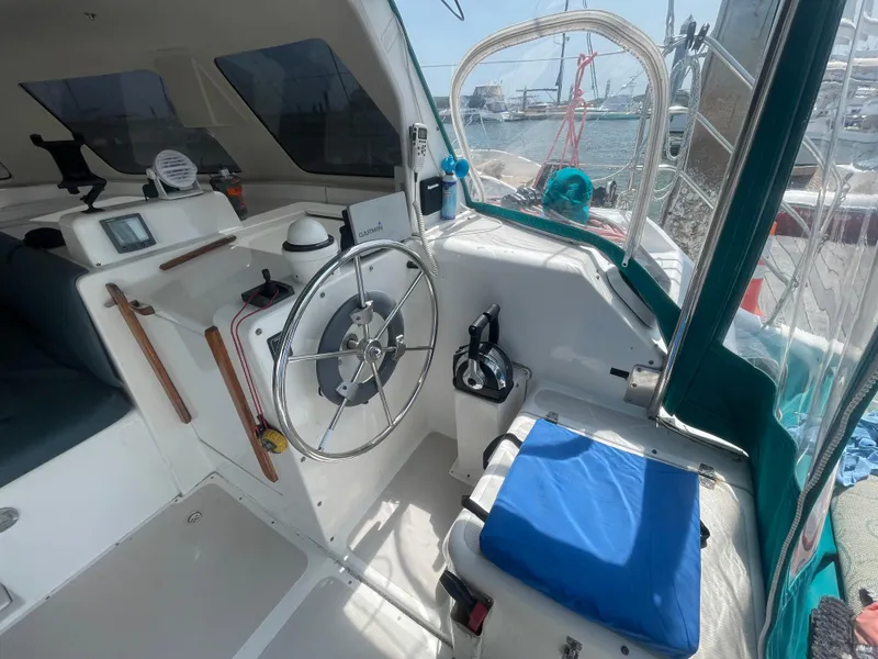 Slide: The Image of Cockpit of a 2001 Seawind 1000 catamaran with steering wheel and navigation equipment. - 39