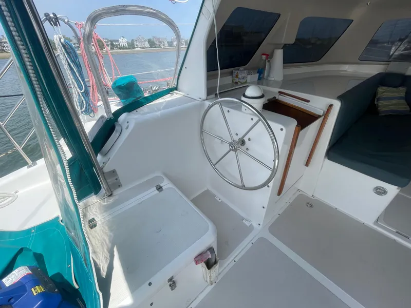 Slide: The Image of Interior view of a 2001 Seawind 1000 catamaran cockpit with steering wheel and seating. - 40