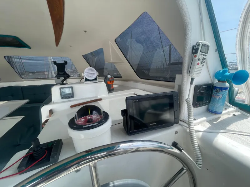 Slide: The Image of Interior view of 2001 Seawind 1000 catamaran cockpit with navigation equipment and steering wheel. - 43