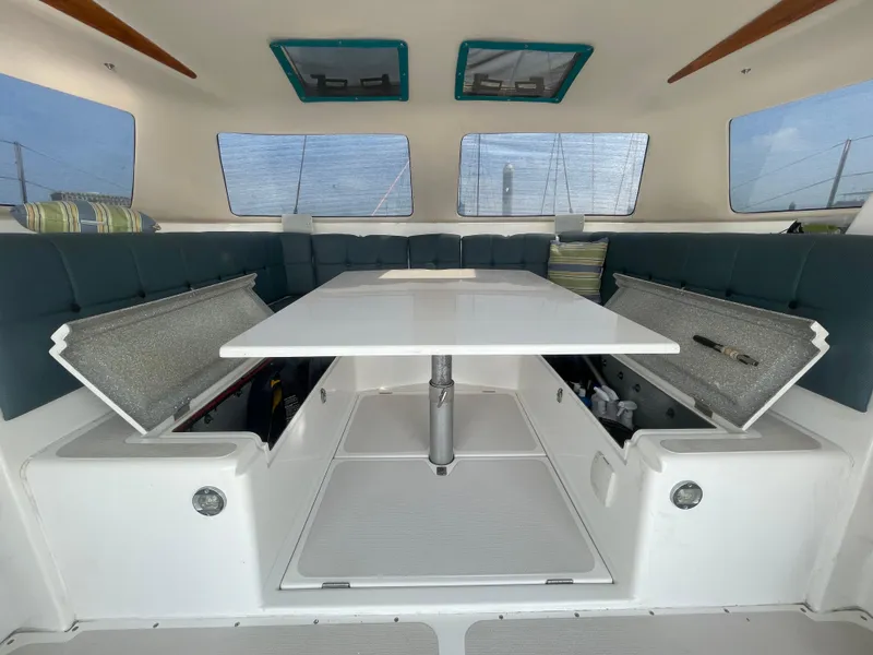 Slide: The Image of Interior of 2001 Seawind 1000 catamaran with convertible seating and storage compartments. - 47