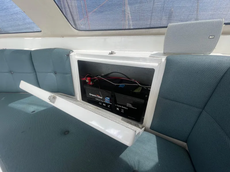 Slide: The Image of Seawind 1000 (2001) interior with open battery compartment and blue seating. - 48