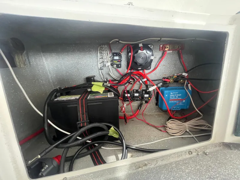 Slide: The Image of Electrical compartment of a 2001 Seawind 1000 catamaran with battery and wiring. - 50