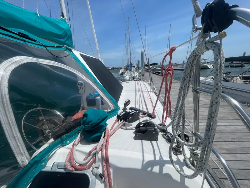 Slide: The Image of Sailboat Seawind 1000, 2001 model, docked with visible ropes and deck equipment. - 7