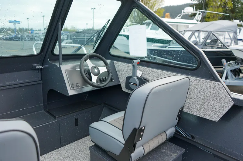 Slide: The Image of 2025 Alumaweld Stryker X202 boat interior with steering wheel and seating. - 11