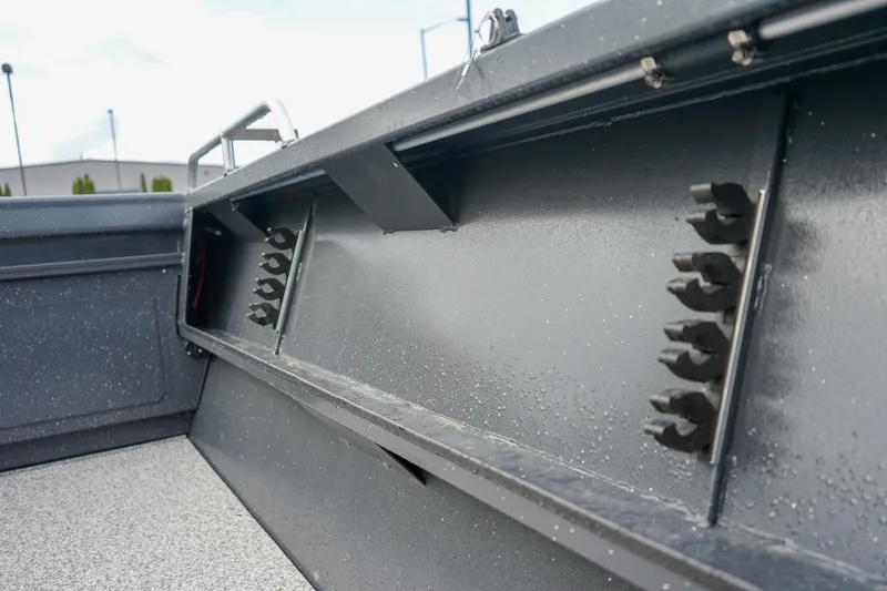 Slide: The Image of 2025 Alumaweld Stryker X202 boat interior with rod holders and textured flooring. - 17