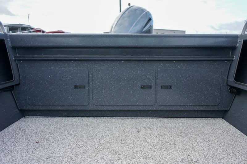Slide: The Image of 2025 Alumaweld Stryker X202 boat interior with storage compartments and speckled flooring. - 18
