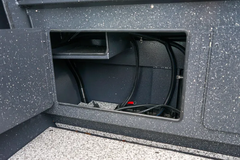 Slide: The Image of Interior compartment of 2025 Alumaweld Stryker X202 boat, showing wiring and storage space. - 19