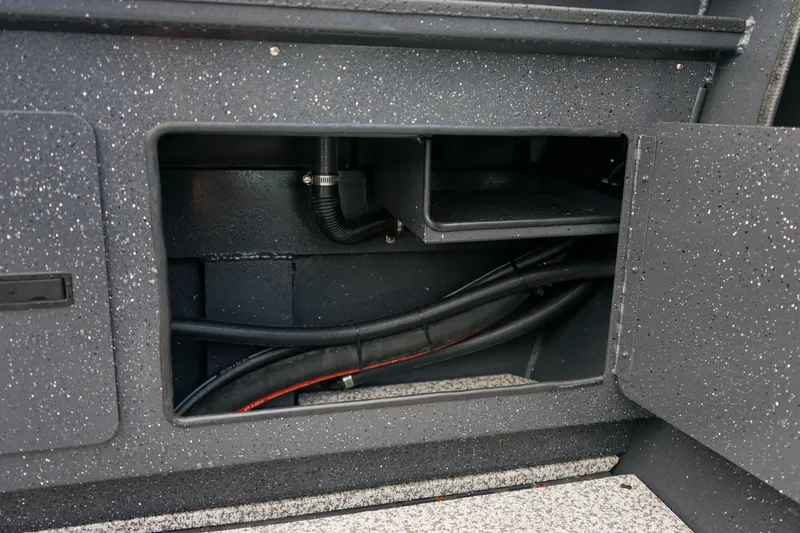 Slide: The Image of Storage compartment of 2025 Alumaweld Stryker X202 boat, showing internal wiring and space. - 21