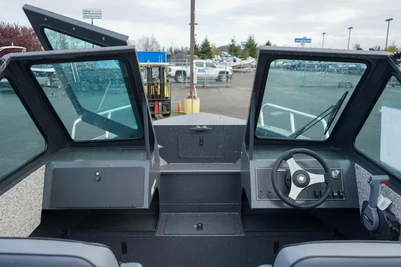 Slide: The Image of 2025 Alumaweld Stryker X202 boat interior with steering wheel and open windshield. - 22