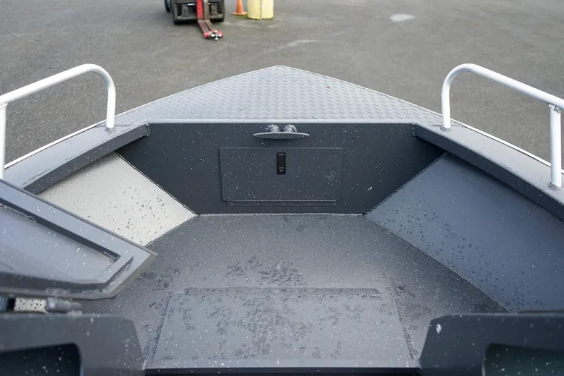 Slide: The Image of 2025 Alumaweld Stryker X202 boat interior with storage compartments and metal railings. - 23