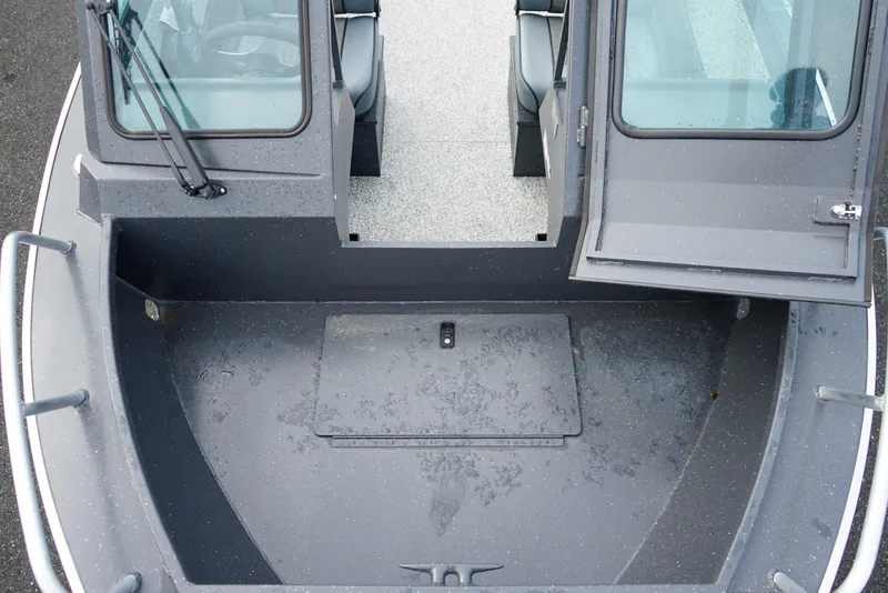 Slide: The Image of 2025 Alumaweld Stryker X202 boat interior with open cabin doors and spacious deck. - 24