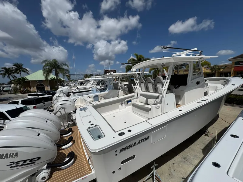 The Image of 2025 Regulator 37 boat with Yamaha engines, docked under a sunny sky. - 1
