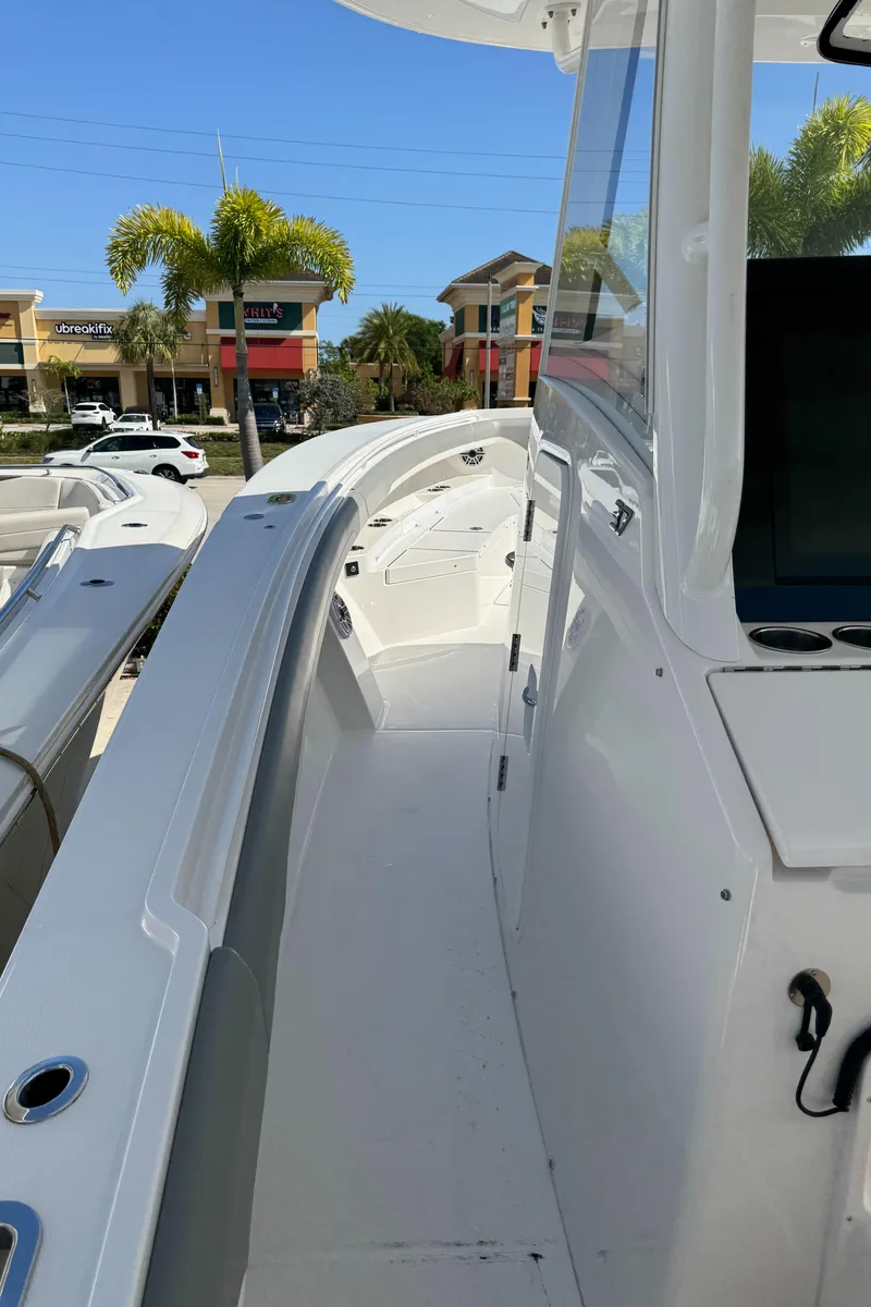 Slide: The Image of 2025 Regulator 37 boat deck with modern design and coastal background. - 11