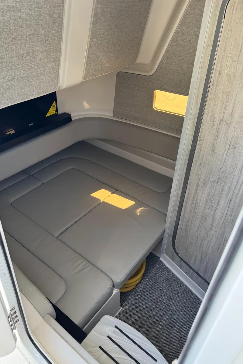 Slide: The Image of Interior cabin of 2025 Regulator 37 boat with cushioned seating and modern design. - 13