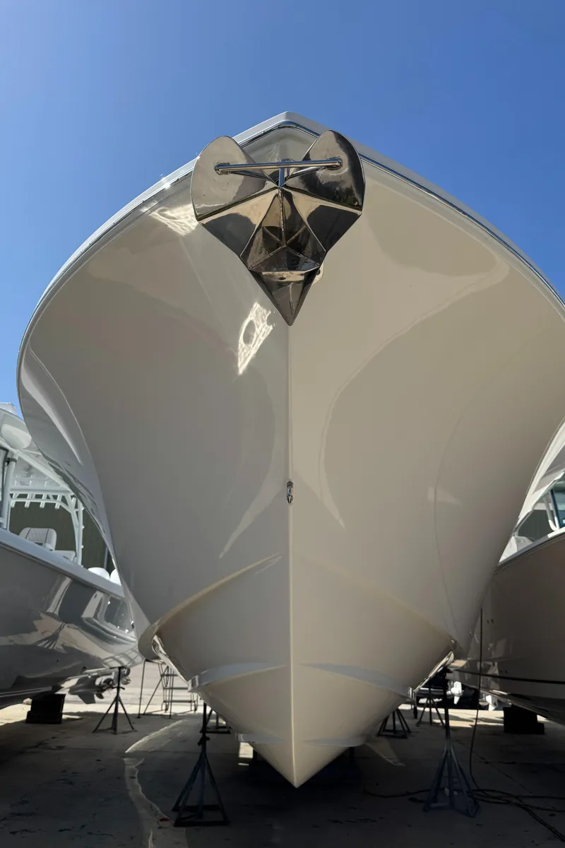 Slide: The Image of 2025 Regulator 37 boat, sleek design, viewed from the front, anchored on stands. - 17