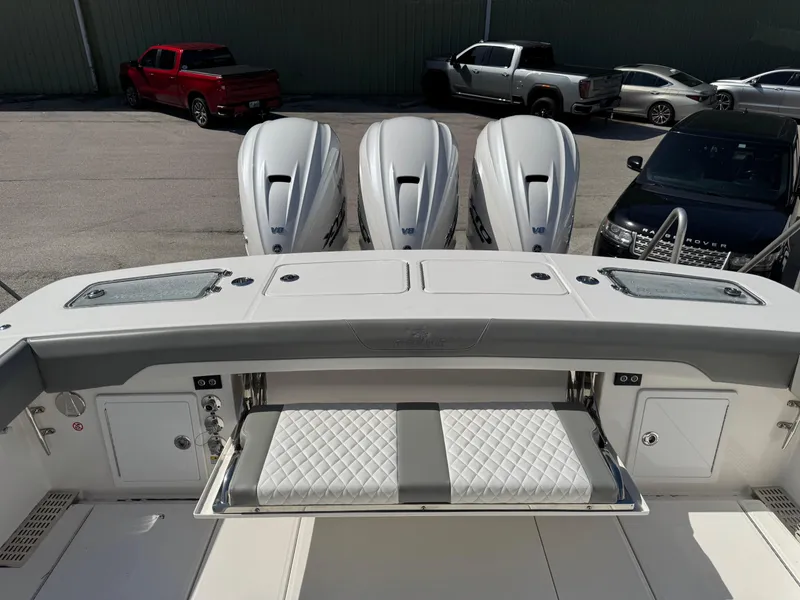 Slide: The Image of 2025 Regulator 37 boat with triple engines and a foldable bench seat. - 4