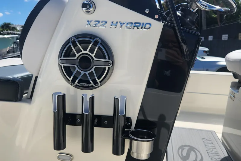 Slide: The Image of 2026 ShearWater X22 HYBRID boat console with JL Audio speaker and rod holders. - 11