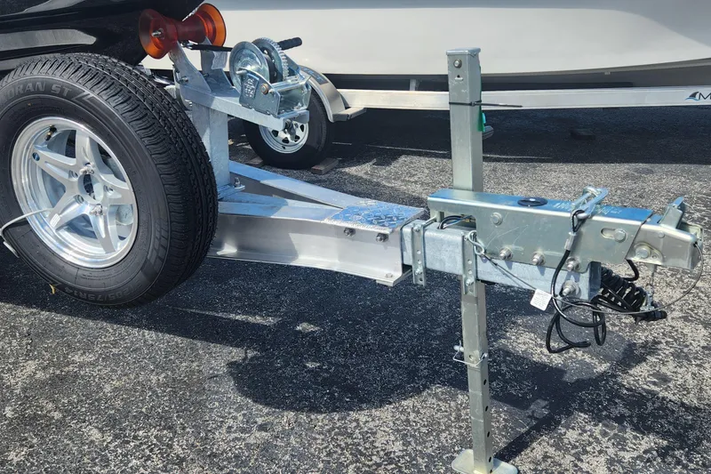 Slide: The Image of Trailer hitch and wheel of 2026 ShearWater X22 HYBRID boat on asphalt. - 16