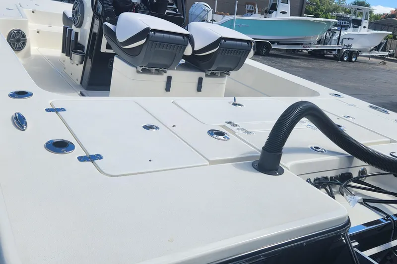 Slide: The Image of 2026 ShearWater X22 HYBRID boat interior with seating and storage compartments. - 6