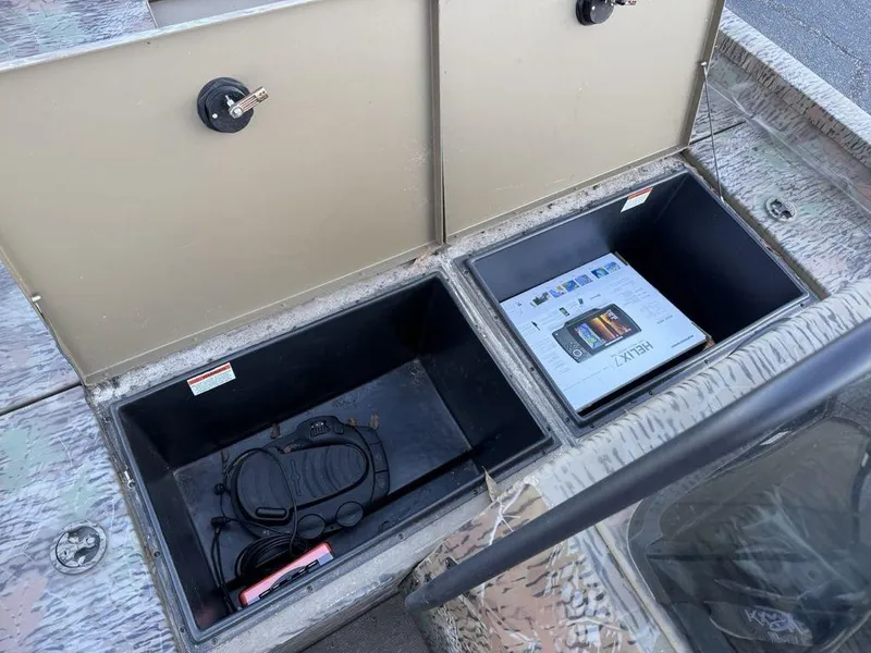 Slide: The Image of Storage compartments on a 2019 G3 Gator Tough 20 CCJ boat, containing equipment and a manual. - 10