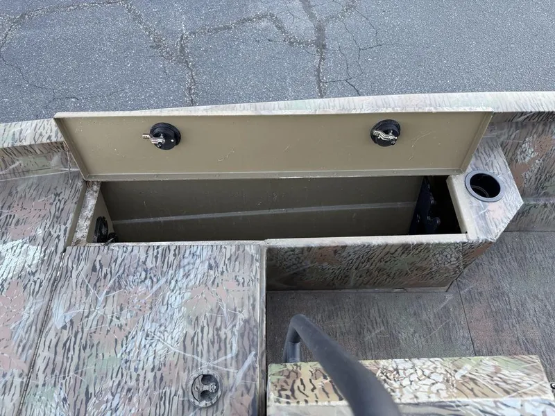 Slide: The Image of 2019 G3 Gator Tough 20 CCJ boat storage compartment with camouflage design and cup holder. - 13