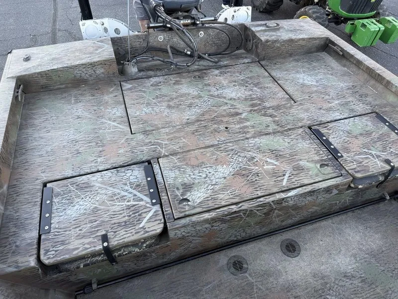 Slide: The Image of 2019 G3 Gator Tough 20 CCJ boat deck with camo pattern and storage compartments. - 16
