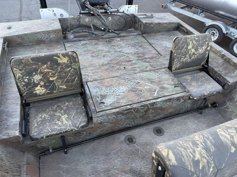 Slide: The Image of 2019 G3 Gator Tough 20 CCJ boat interior with camouflage seating and storage compartments. - 17