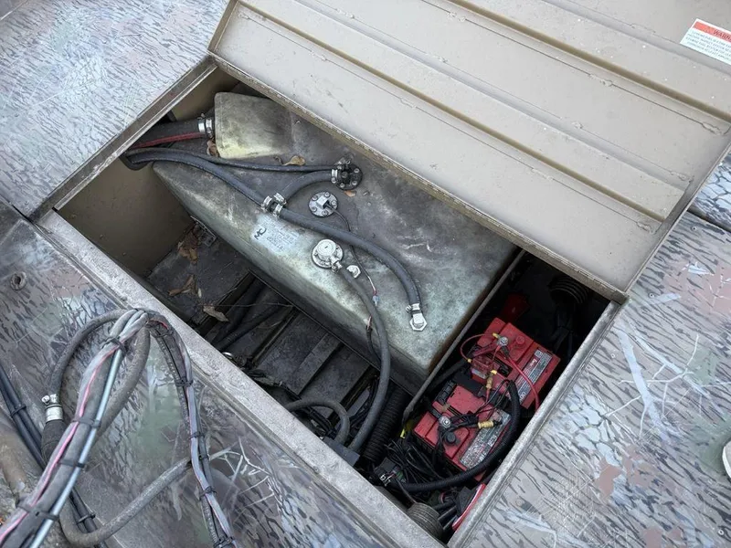 Slide: The Image of 2019 G3 Gator Tough 20 CCJ boat compartment with battery and fuel tank. - 20