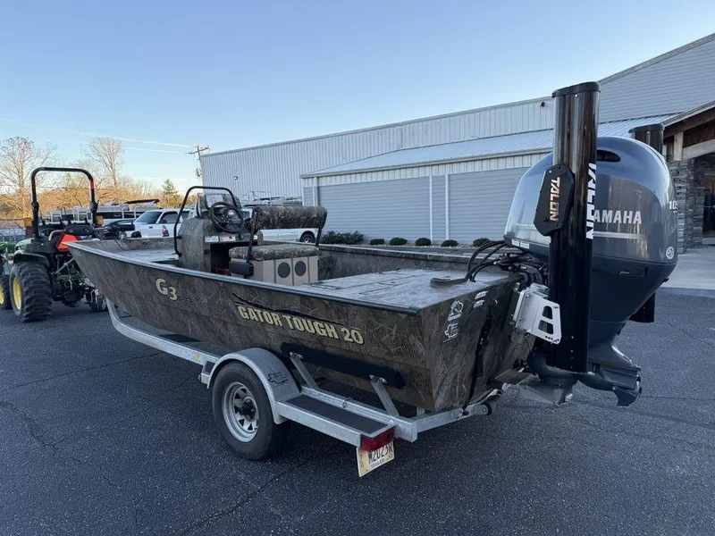 Slide: The Image of 2019 G3 Gator Tough 20 CCJ boat on trailer with Yamaha motor, parked outdoors. - 7